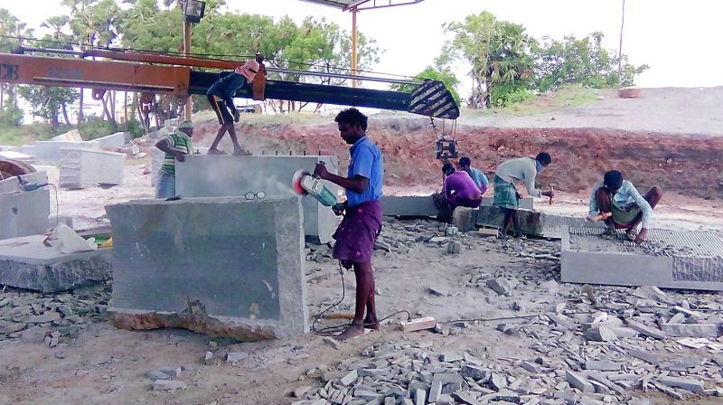 Workers chisel granite blocks into shape at a location in Nellore, AP, for the Yadadri temple in Telangana.