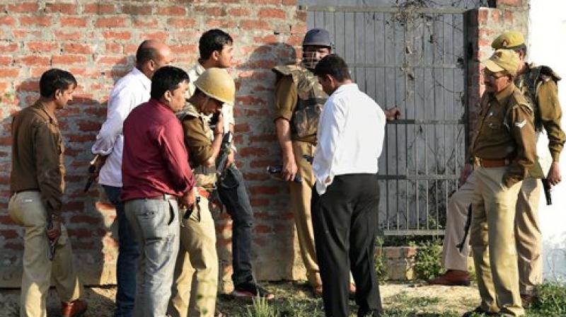 Police personnel during their operation against a suspected terrorist holed up inside a building in the Thakurganj area of Lucknow on Tuesday evening. (Photo: PTI)