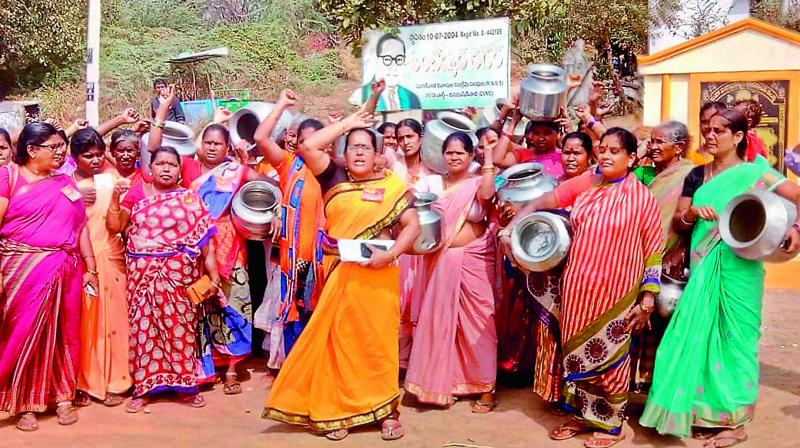 Residents of Ambedkar Colony near Chinnamushidiwada in Visakhapatnam stage a protest with empty pots demanding drinking adequate supply of water on Monday. (Photo: DC)