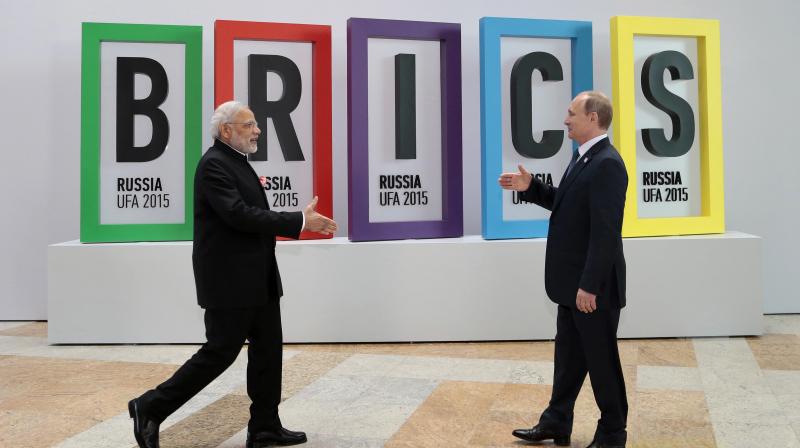 Prime Minister Narendra Modi and Russian President Vladimir Putin approach to shake hands prior to their talks during the BRICS Summit in Ufa, Russia. (Photo: AP/File)