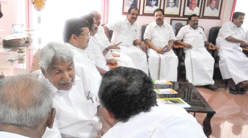 Former chief minister Oommen Chandy discusses a point with his party colleagues at the Congress election committee meeting in Thiruvananthapuram on Monday.  AICC observer Mukul Wasnik and other leaders are also seen. (DC)