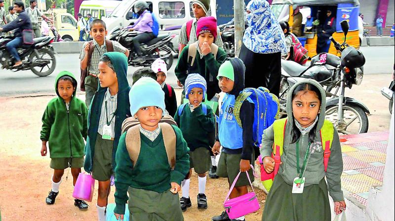 Schoolchildren wear winter clothes as temperature dipped considerably in Hyderabad. (Photo: DC)