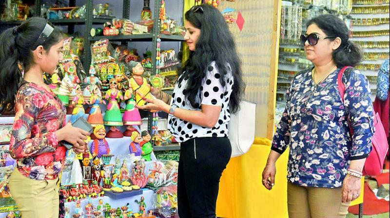 Shoppers look at handicraft toys at a stall at Shilparamam in Hyderabad on Monday. (Photo: DC)