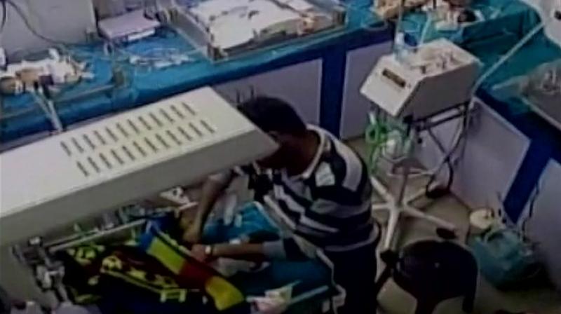 CCTV footage revealing the ward boy breaking the infants leg. (Photo: Twitter | ANI)