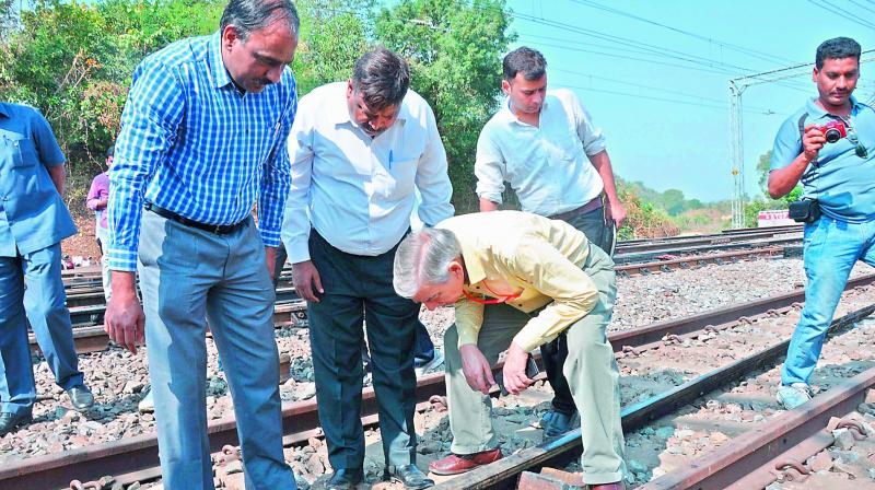 Personnel from National Investigation Agency inspect the damaged railway track on Monday. (Photo: DC)