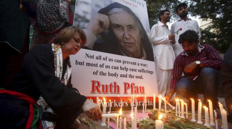 People light candles to pay tribute to Ruth Pfau, a German doctor and nun who devoted her life to the eradication of leprosy in Karachi, Pakistan. (Photo: AP)