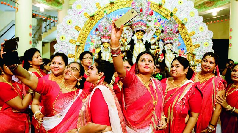 Playing with colours: Bengali women gather infront of the deity to play with sindur and bid adieu to the goddess with renewed hope and blessings for the next year(file photo)