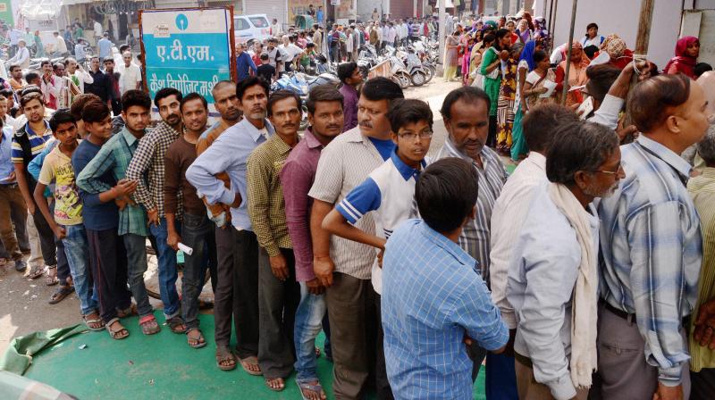 People queue up at an ATM to withdraw money in Jabalpur on Sunday. (Photo: PTI/File)