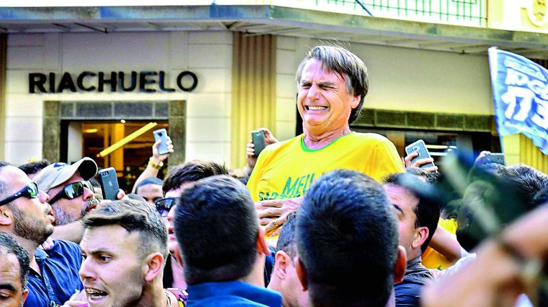 Brazilian right-wing presidential candidate Jair Bolsonaro gestures after being stabbed in the stomach during a campaign rally in Juiz de Fora, Minas Gerais State, in Brazil, on Friday. (Photo:AFP)