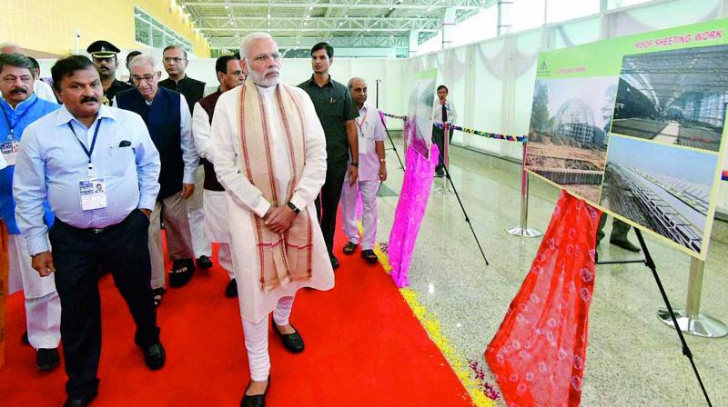 Prime Minister Narendra Modi visits an exhibition after the inauguration of the integrated terminal building at Harni airport, in Vadodara, on Saturday. (Photo: PTI)