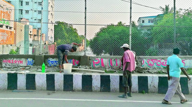 GHMC reconstructing the fence posts on the footpath in Ashok Nagar where an art installation was put up in July this year by Whimaway. (Photo: DC)