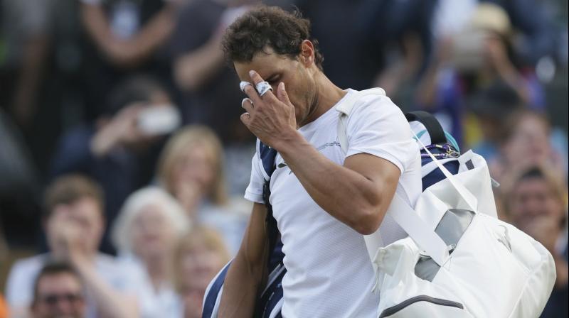 Spains Rafael Nadal leaves the court after losing to Luxembourgs Gilles Muller in their Mens Singles Match at Wimbledon Tennis Championships
