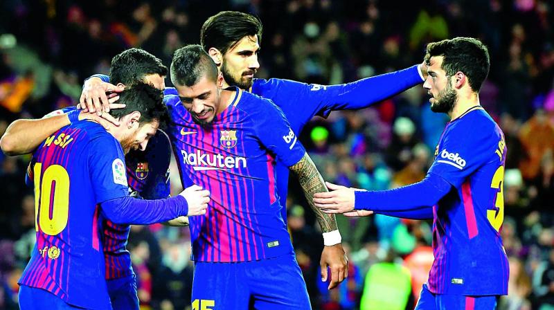 Barcelona players celebrate a goal during their Spanish league football match against Levante at the Camp Nou stadium on Sunday. (Photo: AFP)