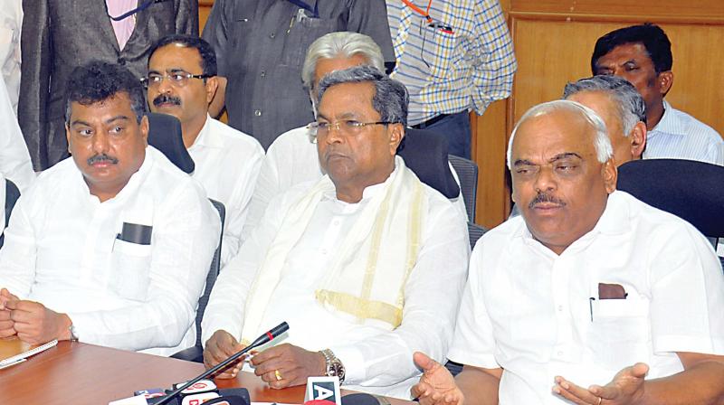 Chief Minister Siddaramaiah and Health Minister Ramesh Kumar address a press conference after a meeting with private doctors at Suvarna Vidhana Soudha in Belagavi on Friday. (Photo: DC)