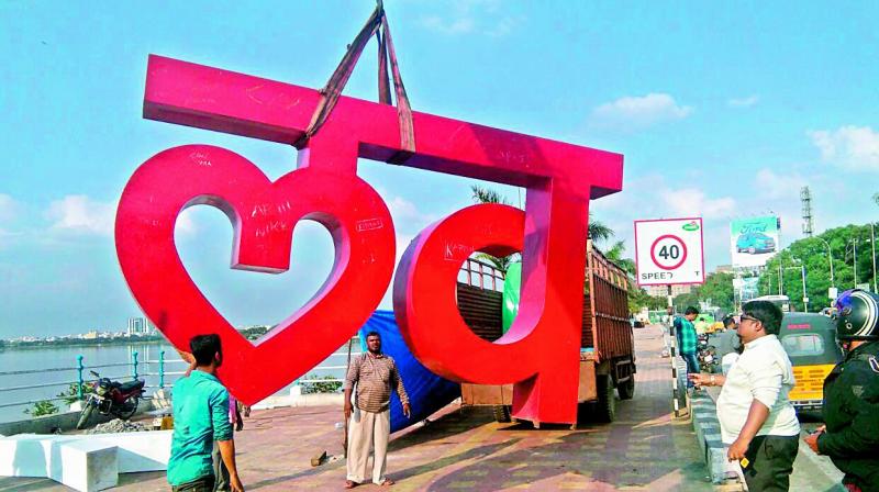 Workers shift the Love Hyd urban sculpture from Tank Bund.
