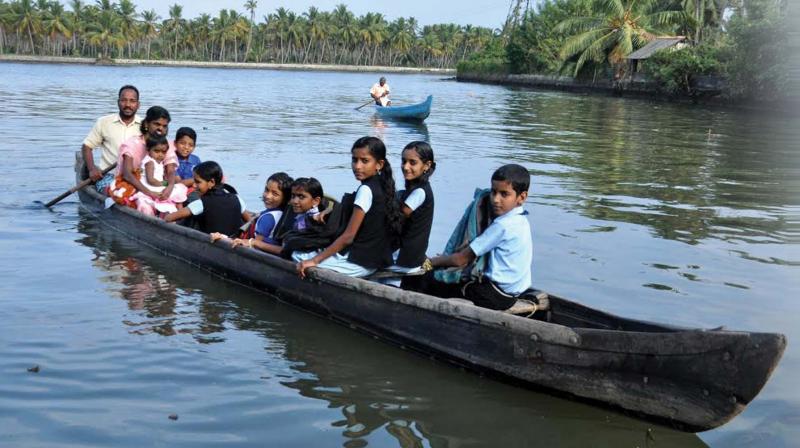Children of Mukkathukariyil Island in Poothotta cross Vembanad Lake to reach school. (Photo: SUNOJ NINAN MATHEW)