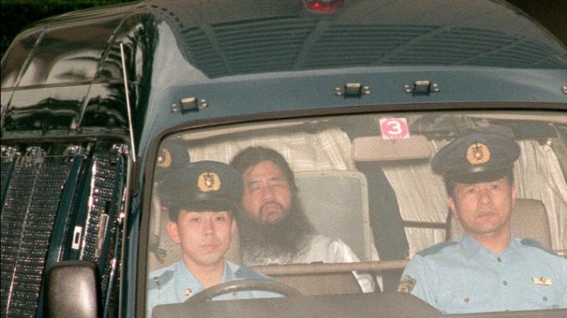 The \guru\ with his wild hair and unkempt beard, once led up to 10,000 followers, including some who in 1995 targeted the Tokyo subway in a shocking chemical attack that killed 13 people and injured thousands more. (Photo\ AFP)