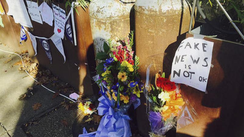 Flowers and notes left by well-wishers are displayed outside Comet Ping Pong, the pizza restaurant in Washington. (Photo: AP)