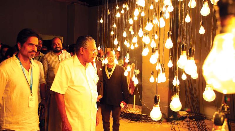 Chief minister Pinarayi Vijayan watches an artwork at Aspinwall before the inauguration of Kochi Muziris Biennales third edition in Kochi on Monday. CPM leader  P. Rajeev is also seen. (Photo: ARUNCHADRA BOSE)