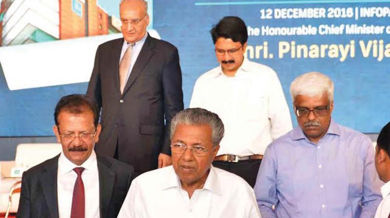 Chief Minister Pinarayi Vijayan with IBS executive chairman V.K. Mathews, IT secretary M. Sivasankar and Infopark CEO Hrishikesh Nair after inaugurating the companys Kochi campus project on Monday. 	(Photo: DC)