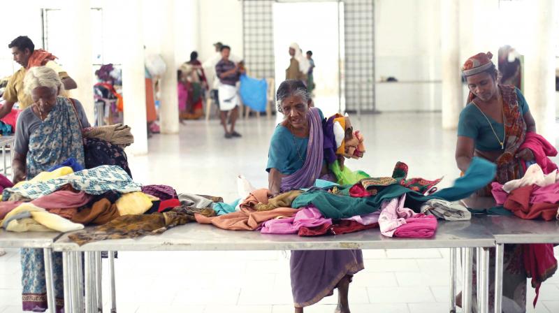 Migrant labourers collect dress items from the Swap Shop opened at Jubilee Hall in Kozhikode as part of Haritha Kerala Mission.  DC FILE