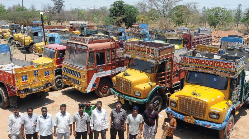 Lorries parked near Mysuru on Friday in view of strike called by truck owners against the new insurance policy