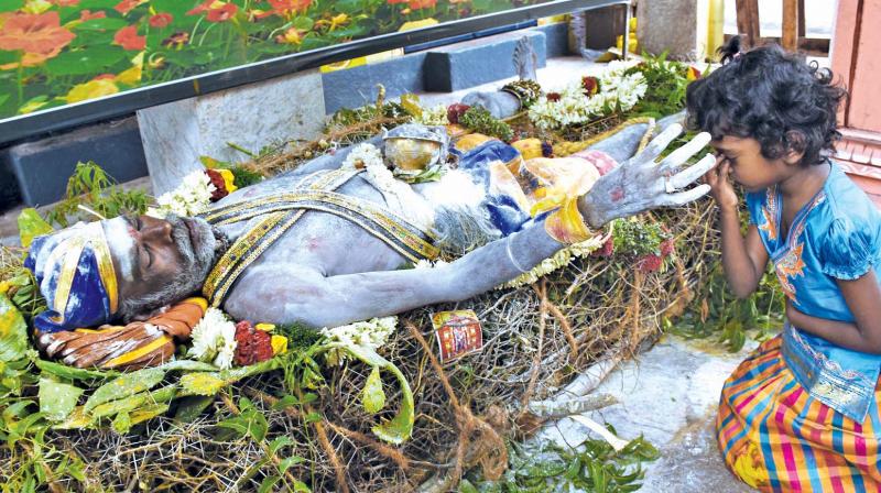 A 45-year-old AIADMK cadre Irulandilying on a bed of thorns seeking divine intervention of goddess Pechi Amman for the speedy recovery of  Chief Minister  J. Jayalalithaa in Madurai on Saturday. (Photo: DC)