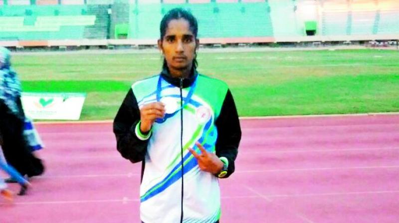 G. Maheshwari poses with her womens 3,000 metres steeple chase silver medal at the Fed Cup Junior National athletics in Coimbatore on Sunday.