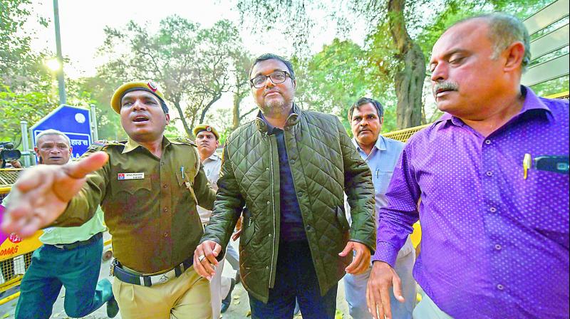 Karti Chidambaram escorted by policemen to the Patiala House court in New Delhi on Wednesday.  PTI