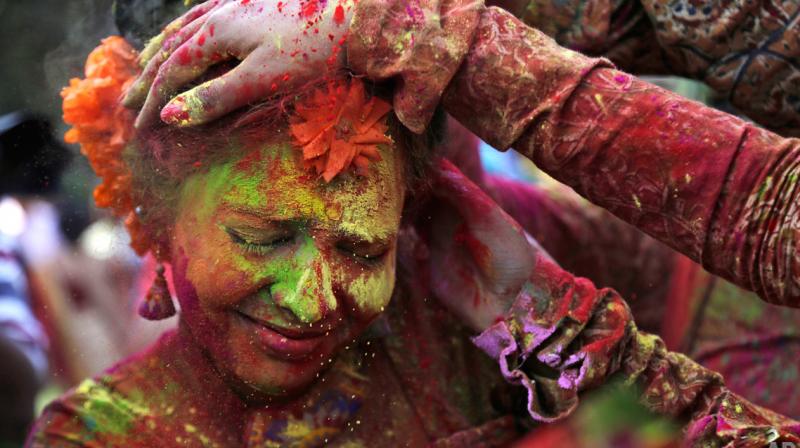 While the festival of colours is all fun and games, harsh chemicals and metal oxides mixed in colours can take a serious toll on your mane. (Photo: AP)