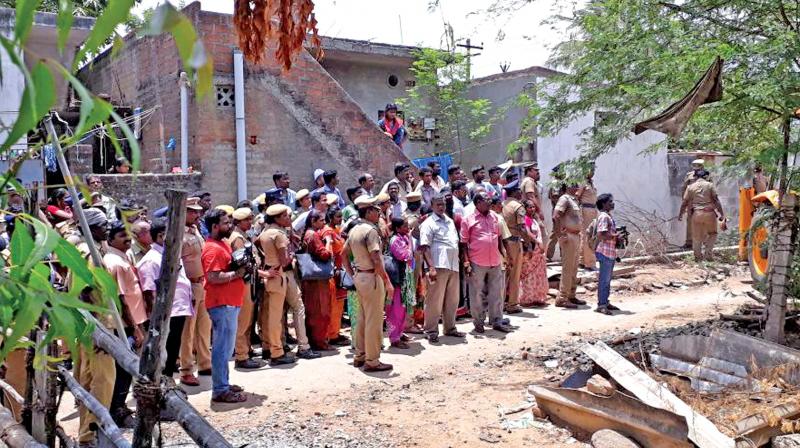 High tension  prevailed near  Adyar banks at Anakaputhur, Pallavaram, as revenue officials evicted nearly 300 families, on Thursday. The Sankar Nagar police also registered cases against 100 persons for opposing the  eviction drive and preventing government officials from discharging their duty.	(Photo: DC)