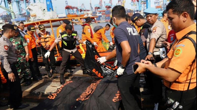 Members of a rescue team line up body bags at a port in North Jakarta. (Photo: AFP)