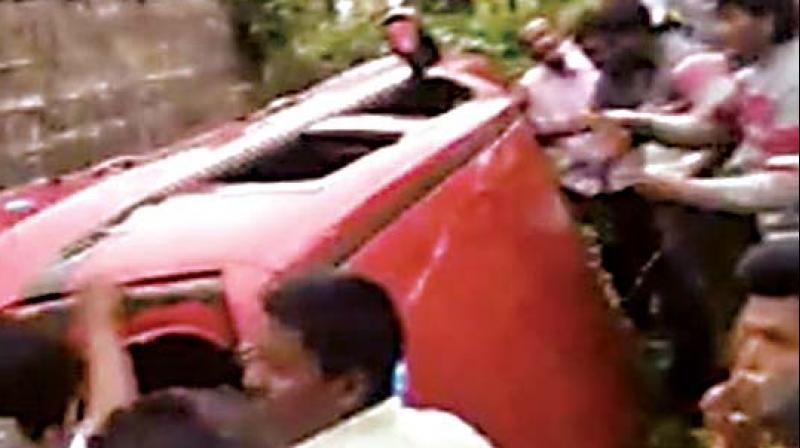 People attacking three men inside the car, believing them  to be child lifters, at Murki village near Karnataka-Maharashtra border on Friday.