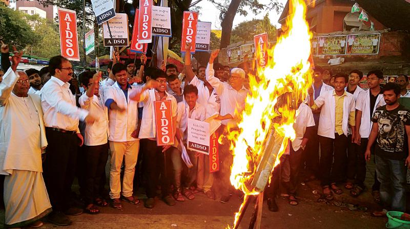 Medicos burn the effigy of the NMC Bill in a protest held at Mysore Bank Circle in the city on Tuesday. (Photo: DC)