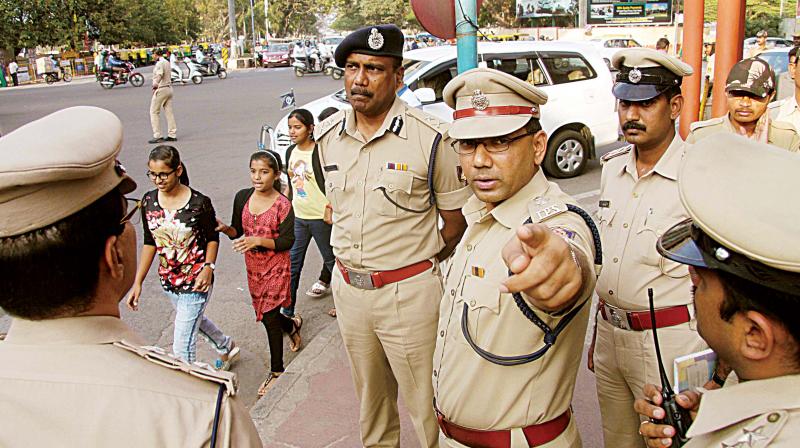 Sandeep Patil, Deputy Commissioner of Police, Central Division, Bengaluru City, with other officers on Friday oversee the arrangements made on Brigade Road for New Year celebrations on Saturday. (Photo: DC)