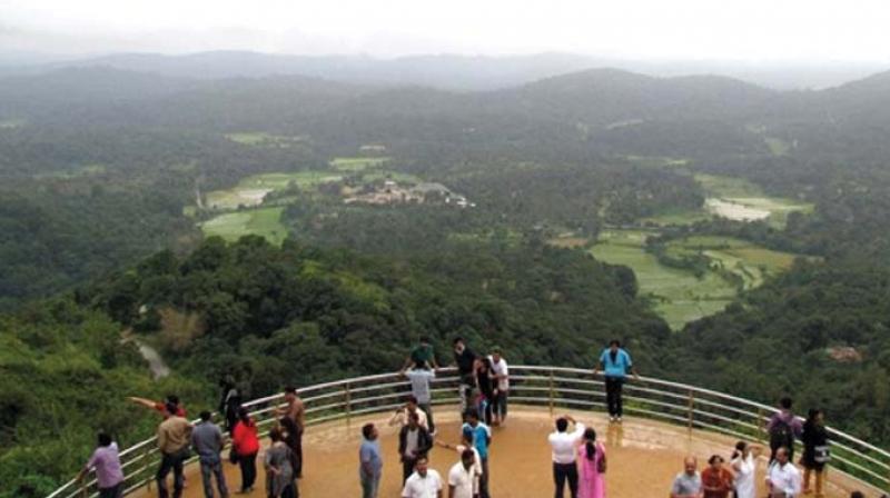 A file photo of tourists at the Raja Seat in Madikeri