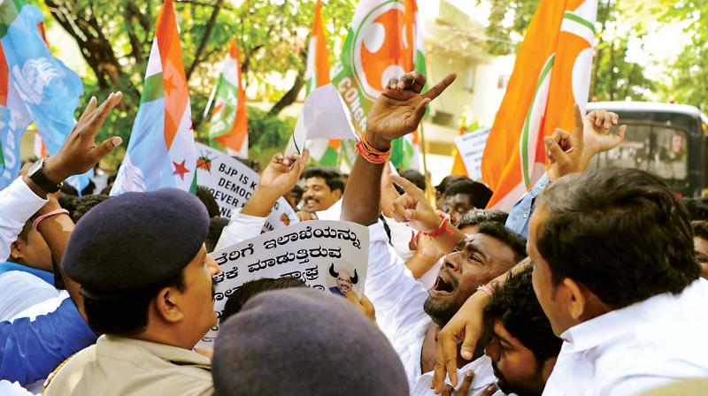 Cong workers protest in front of D K Shivakumars house. (Photo: DC)