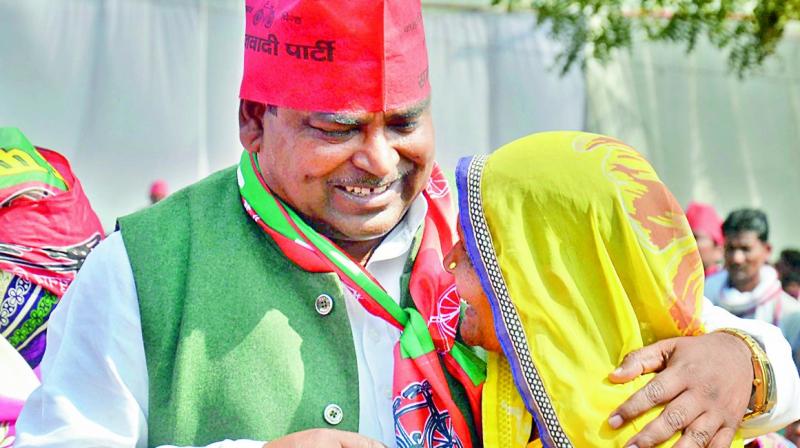 SP candidate from Amethi Gayatri Prasad Prajapati is greeted by one of his supporters during an election rally in Amethi on Monday. (Photo: PTI)