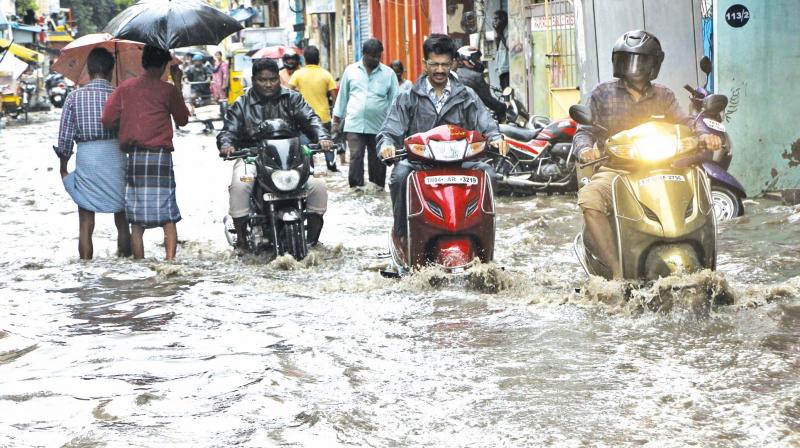 Motorists struggle to wade through water-logged Walltax Road after Wednesdays downpour in Chennai. (Photo: DC)