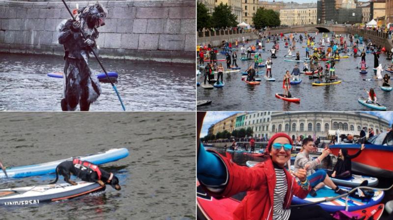 Stand up paddle boarders steer along Russia Griboedov Canal at water sport festival