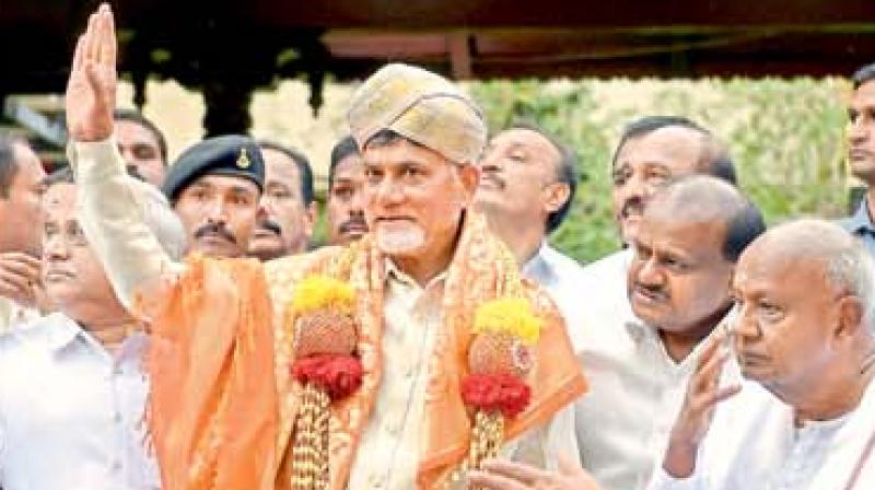 AP Chief Minister N. Chandrababu Naidu waves after being felicitated by Karnataka CM H.D. Kumaraswamy and former PM H.D. Deve Gowda in Bengaluru.  (PTI)