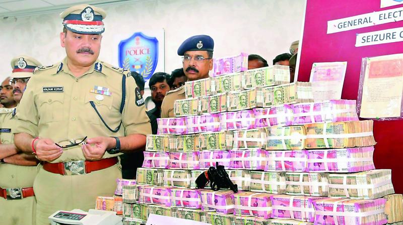 Police commissioner Anjani Kumar shows money seized in checks on Wednesday.  (GANDHI)