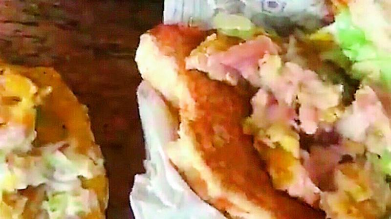 This image grab from a viral video shows raw chicken served in a burger at McDonalds Kharkhana branch.