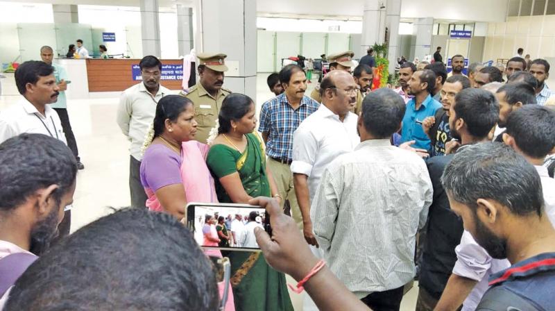 Fisheries minister D. Jayakumar with the rescued labourers at the Chennai airport on Wednesday (Photo: DC)