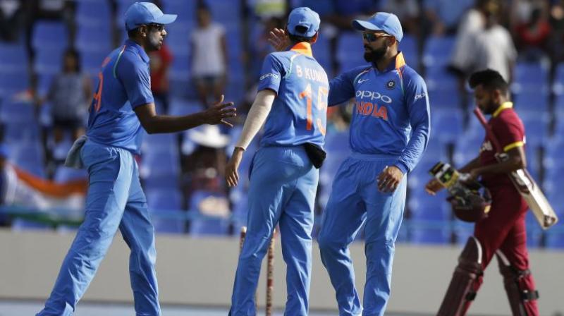 Indias captain Virat Kohli, third from left, greets bowler Ravichandran Ashwin after they defeated West Indies by 93 runs in their third ODI cricket match at the Sir Vivian Richards Stadium in North Sound, Antigua and Barbuda, Friday.
