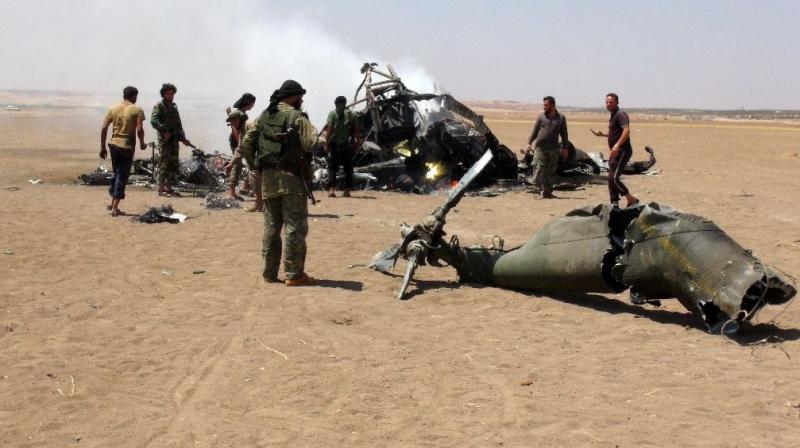 Syrian rebels look at the wreckage of a Russian military transport helicopter shot down between Idlib province, and neighbouring Aleppo. (Photo: AFP)