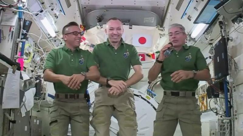 In this undated image provided by NASA, NASA astronauts Joe Acaba, left, Randy Bresnik, centre and Mark Vande Hei give interviews on the International Space Station. The trio along with their international crewmates plan to feast on pouches of Thanksgiving turkey and single-serving bags of sides. (Photo credit: AP)