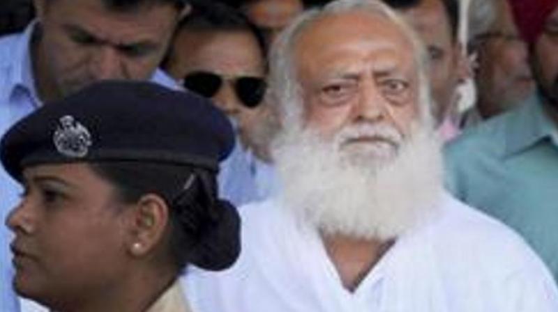 Asaram, who was arrested from his Indore ashram by Jodhpur Police, arrives at Jodhpur airport. (Photo: PTI | File)