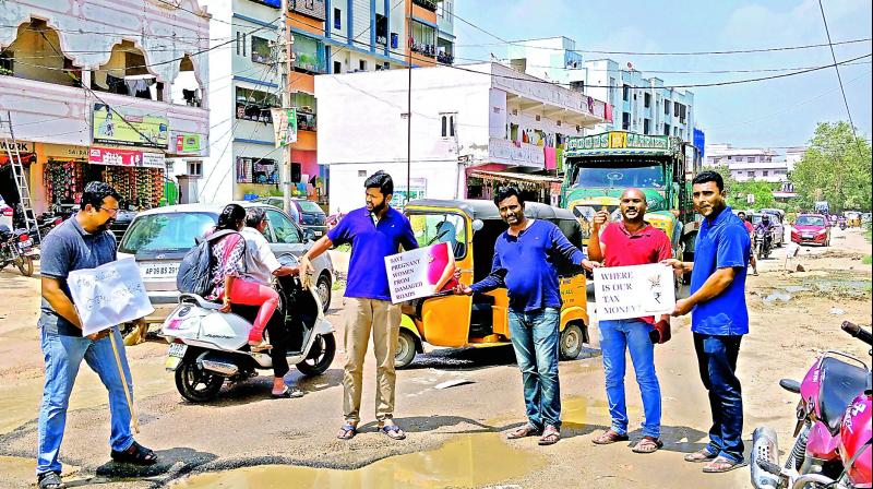 Residents and techies in Ameenpur hold a protest against poor roads on Tuesday.