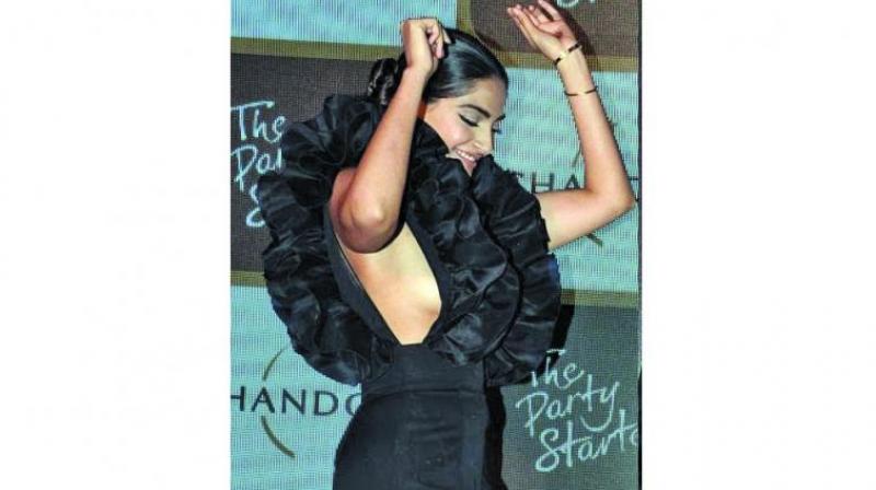 Sonam Kapoor sported a black dress, which revealed her sideboobs, at an event.